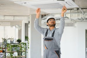 Concentrated,Young,Indian,Engineer,Setting,Up,Air,Conditioner.